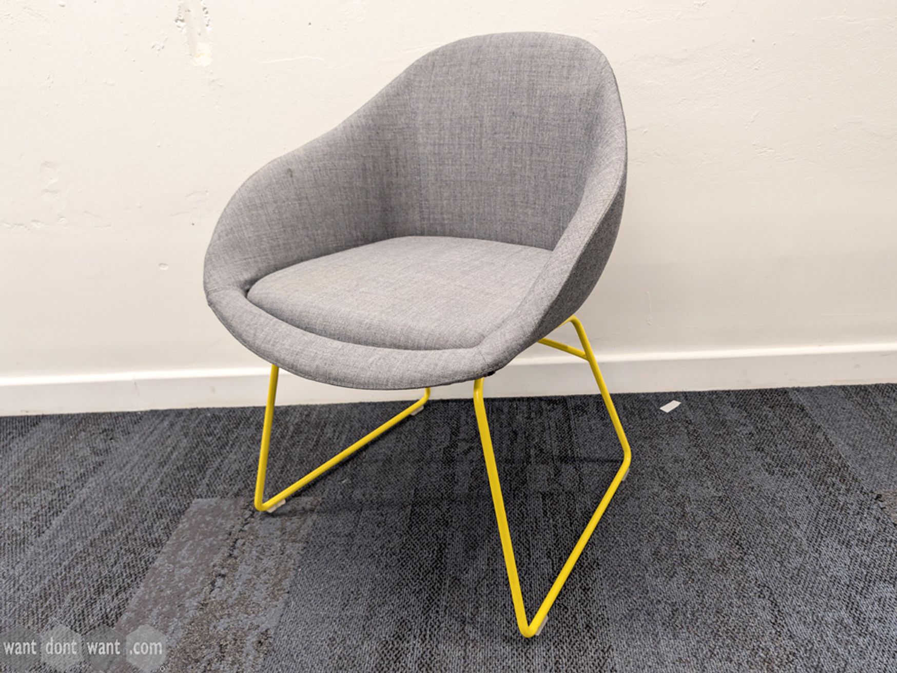 Used NaughtOne grey upholstered chair with yellow legs