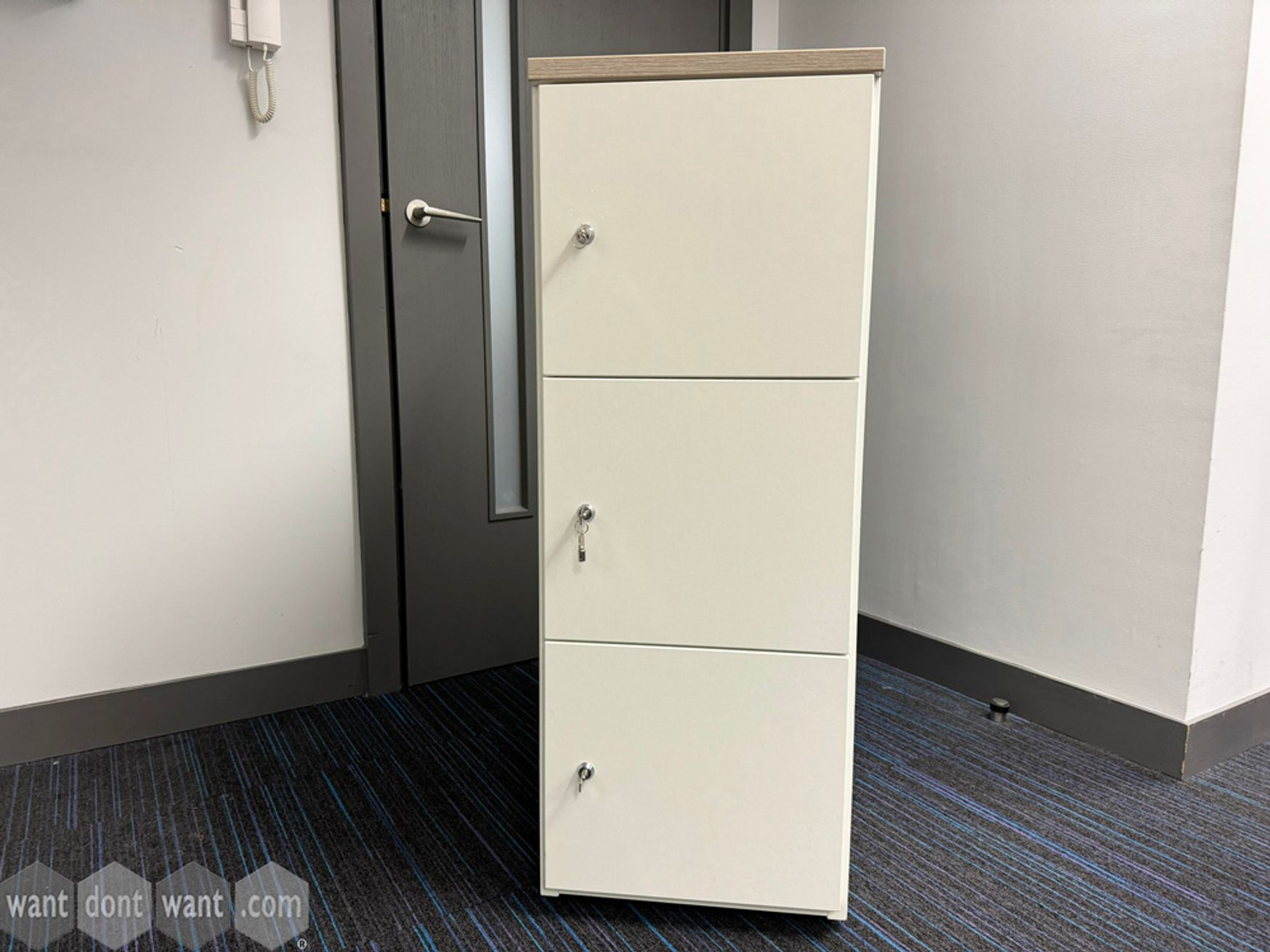 Used white 3-door locker with wooden top
