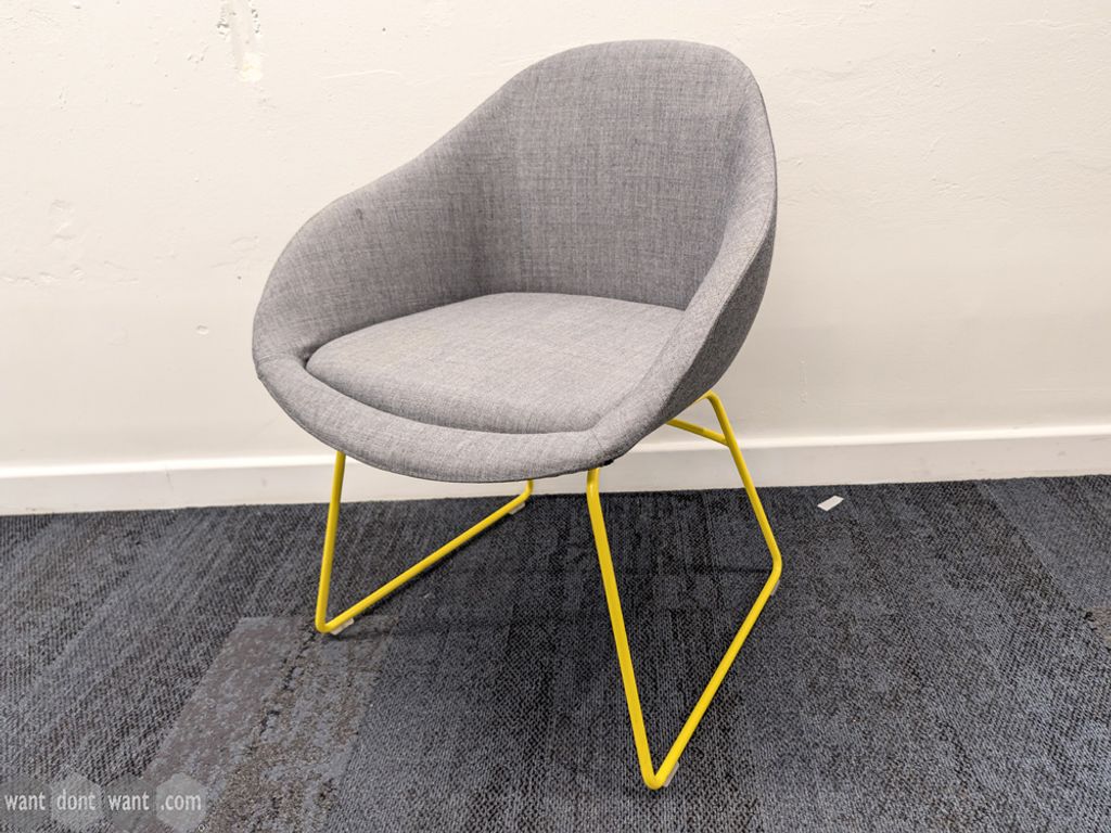 Used NaughtOne grey upholstered chair with yellow legs
