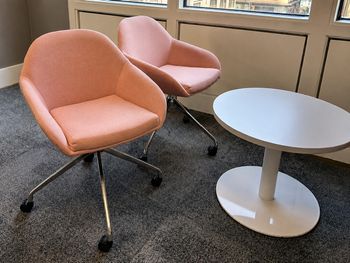 Used VCF pink upholstered chair on pyramid castors