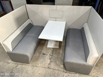 Used grey fabric seating booth with table