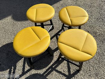 Used yellow 3-legged stool 