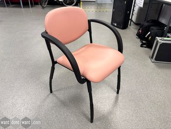 Used stacking chairs with light pink seats and black frame