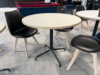 Used café table with white tops and black metal base.