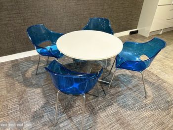 Used transparent blue-tinted plastic 'Opal' chairs with chrome legs.