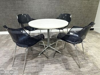 Used transparent black-tinted plastic 'Opal' chairs with chrome legs.