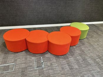 Used interlinking poufs of various colours