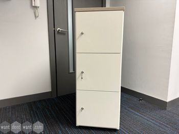 Used white 3-door locker with wooden top
