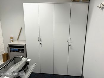 Used white 2-door high storage cupboards with shelves