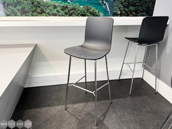 Used Vitra 'Hal' stools with black shell and chrome frame with foot rest.