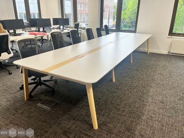 Used 1600mm Nova 6-person bench desk/collaborative table with white tops and natural ash leg frame