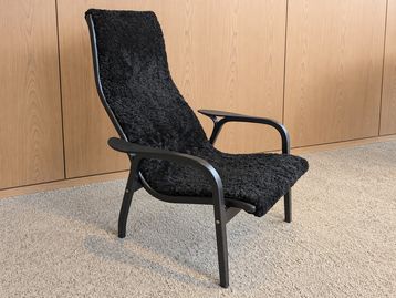 Used Swedese Lamino Easy Chair in black sheepskin on black lacquered beech frame