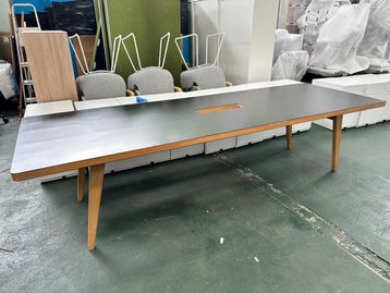 Used 3000mm James Burleigh meeting table with black top and wooden legs