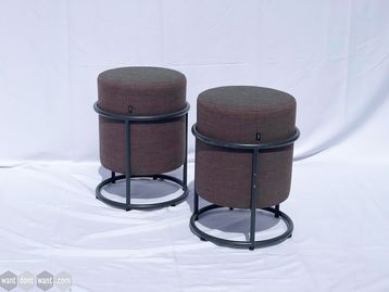 Used Cor 'drop' footstool upholstered in fabric with grey tubular frame.
